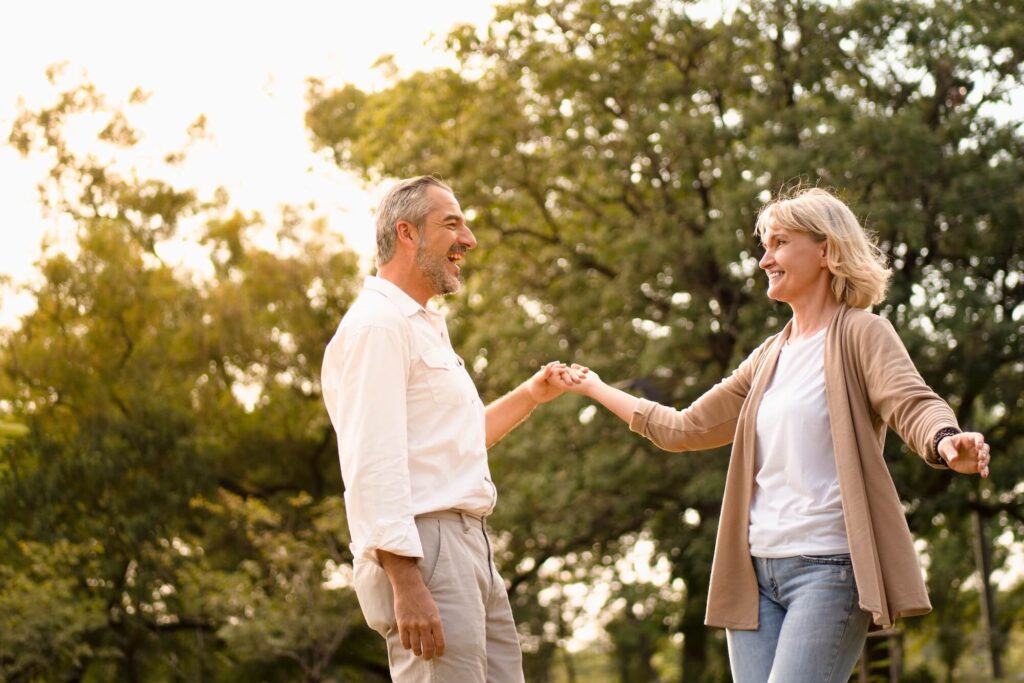 Couple enjoying dancing together outside in nature