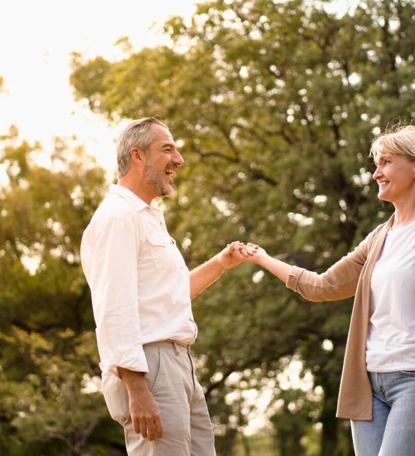 Couple enjoying dancing together outside in nature