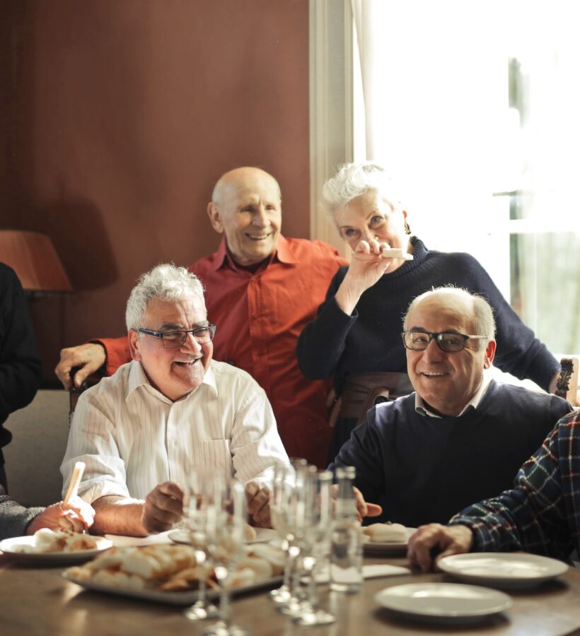 Group of friends enjoying chatting and eating together