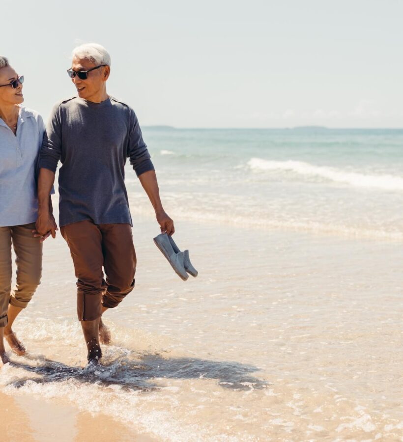 Couple enjoying their walk on the beach together